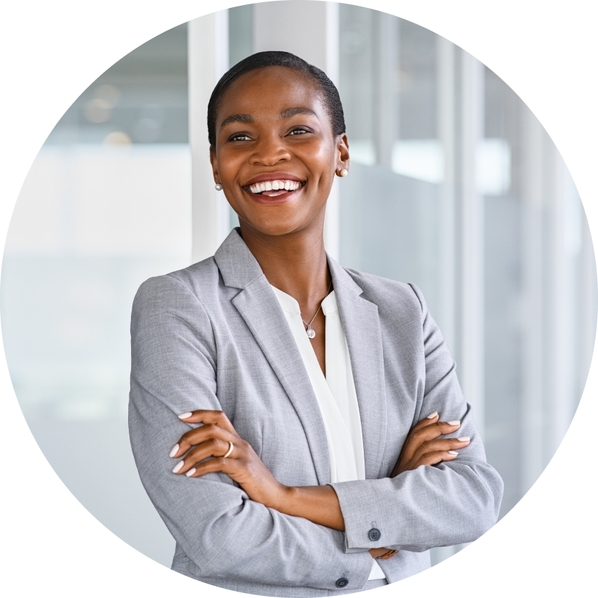 Actor portrayal of a woman in a gray blazer smiling with her arms crossed over her chest