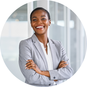 Actor portrayal of a woman in a gray blazer smiling with her arms crossed over her chest