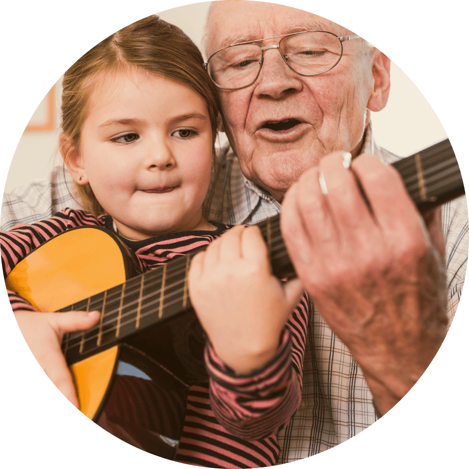 Grandpa and granddaughter playing guitar together
